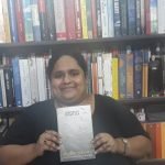 Fiza Pathan posing with the book Disciples by Austin Wright