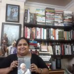Fiza Pathan holding the book the Last Testament by Benedict XVI
