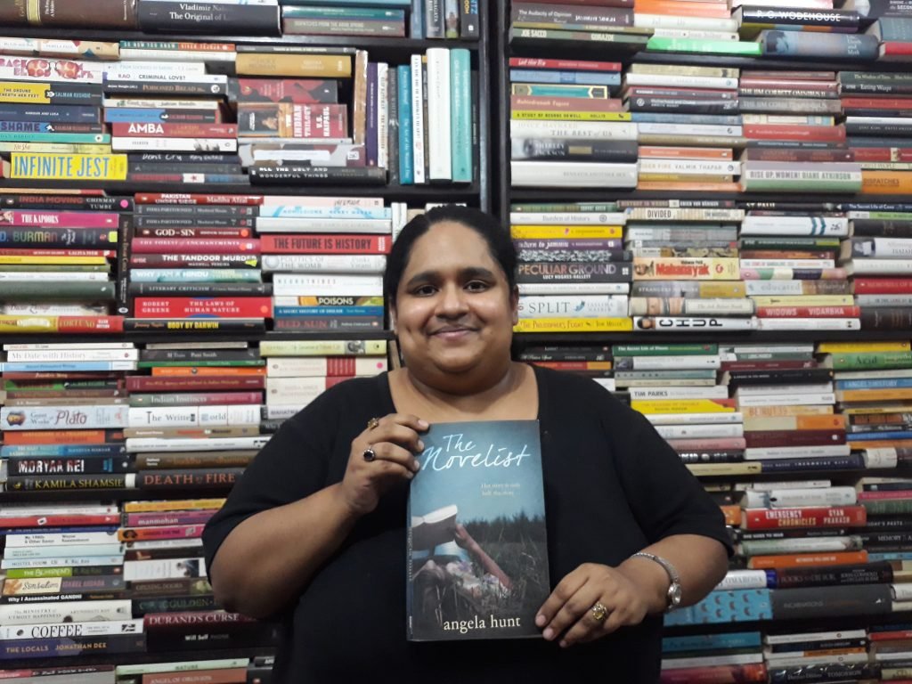 Fiza Pathan posing with the book The Novelist by Angela Hunt