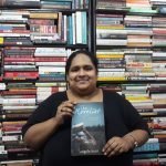 Fiza Pathan posing with the book The Novelist by Angela Hunt