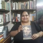 Fiza Pathan holding the book Rabbi Jesus by Bruce Chilton